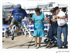 Doing whata he's told Green Deane takes a flying leap at a Greek Festival. 